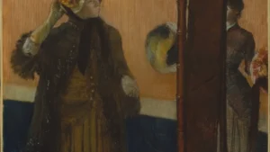 Tranh At the Milliner's (Edgar Degas, 1882) cảnh người phụ nữ thử mũ ở cửa hàng, minh họa chủ đề thuế hồng pink tax